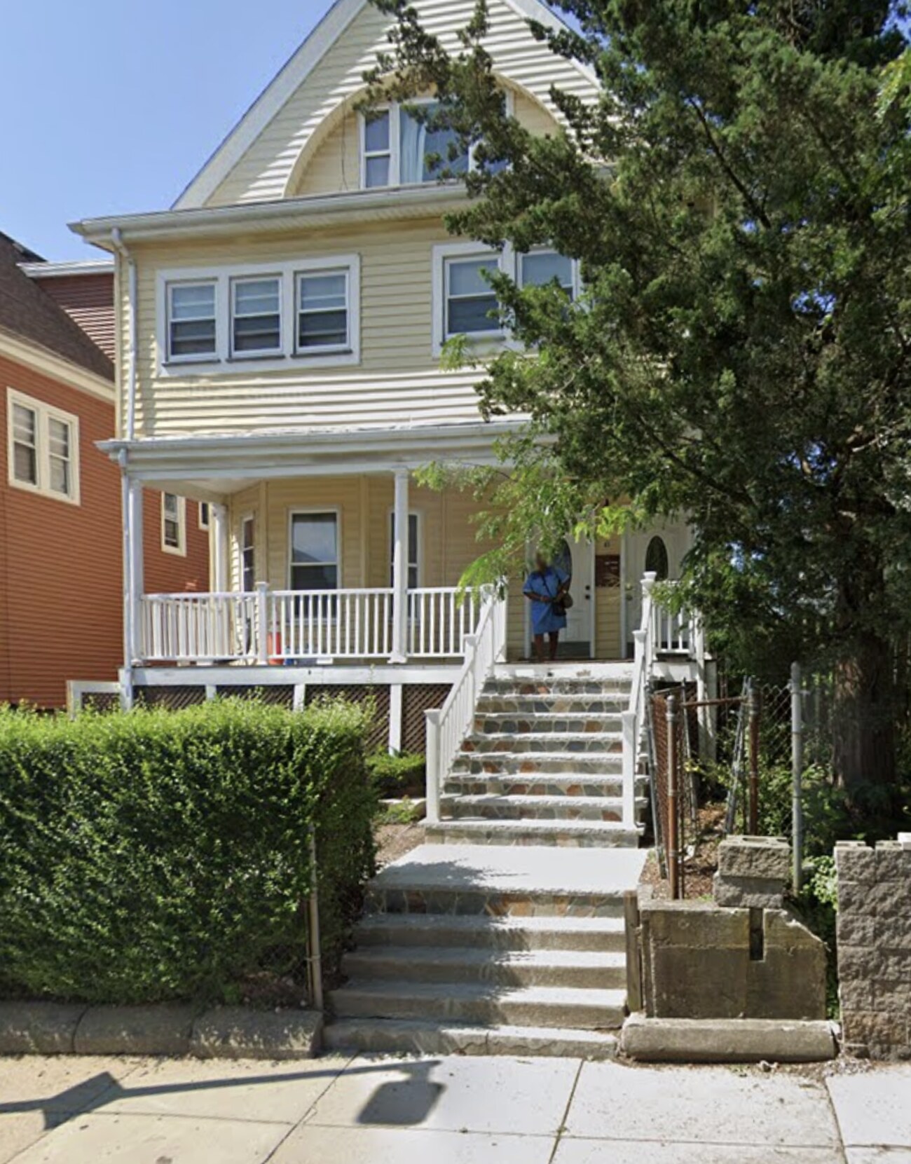 Exterior of the Blue Hill Residences home in Dorchester, with a covered front porch